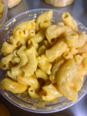 top view close up of macaroni and cheese in small plastic cup