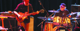guitar player and drummer playing on stage during concert