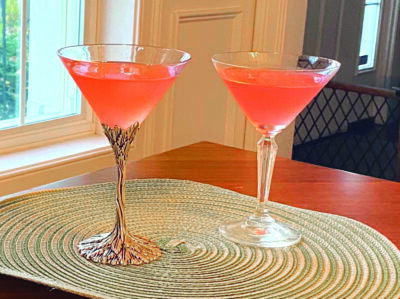 2 cocktails in martini glasses on placemat on table