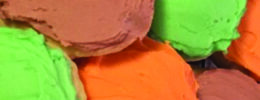 close up of round sugar cookies covered in different colors of frosting