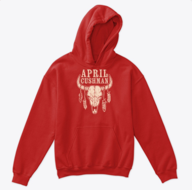 hoodie featuring illustration of cattle skull with feathers hanging from horns, and words April Cushman above