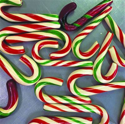 red and green striped candy canes on sheet, seen from above