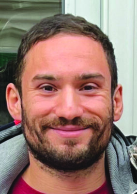headshot of smiling man with beard