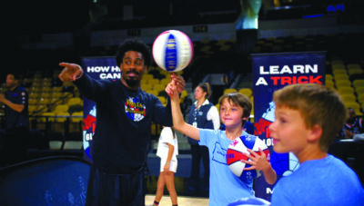 basketball player in gym at event with children