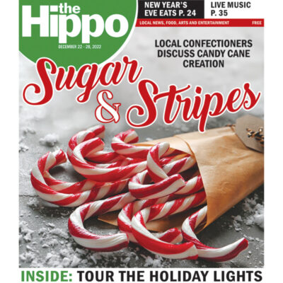 Hippo cover, title sugar and stripes, displaying packet of candy canes on gray surface