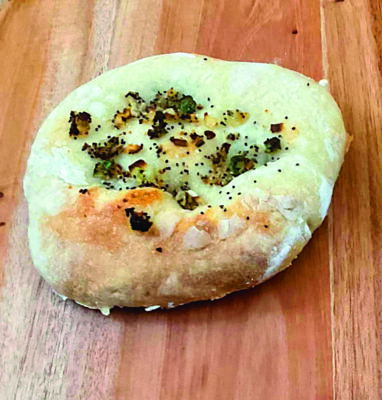 a bialy on a wooden table
