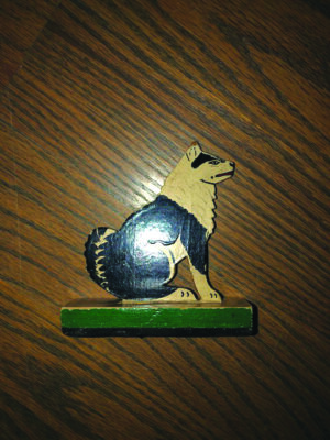 flat wooden dog on wooden block, painted