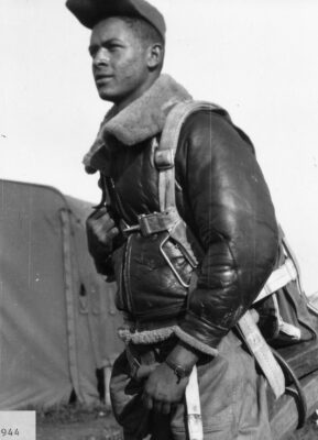 old photograph of a black airman getting ready for a flight