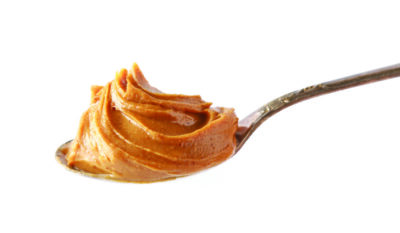 spoon of peanut butter isolated on white background