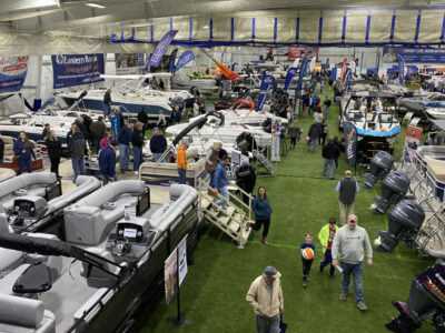 large indoor event space, filled with rows of hobby boats, people milling around