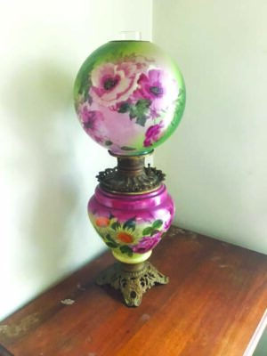 antique oil lamp with painted flowers