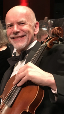 cropped shot of man wearing tuxedo holding up violin and smiling
