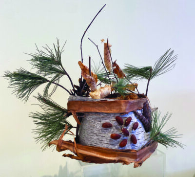 sculptural hat made of birch bark and pine needles