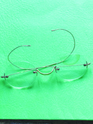 pair of old spectables made of wire attached to round glass pieces