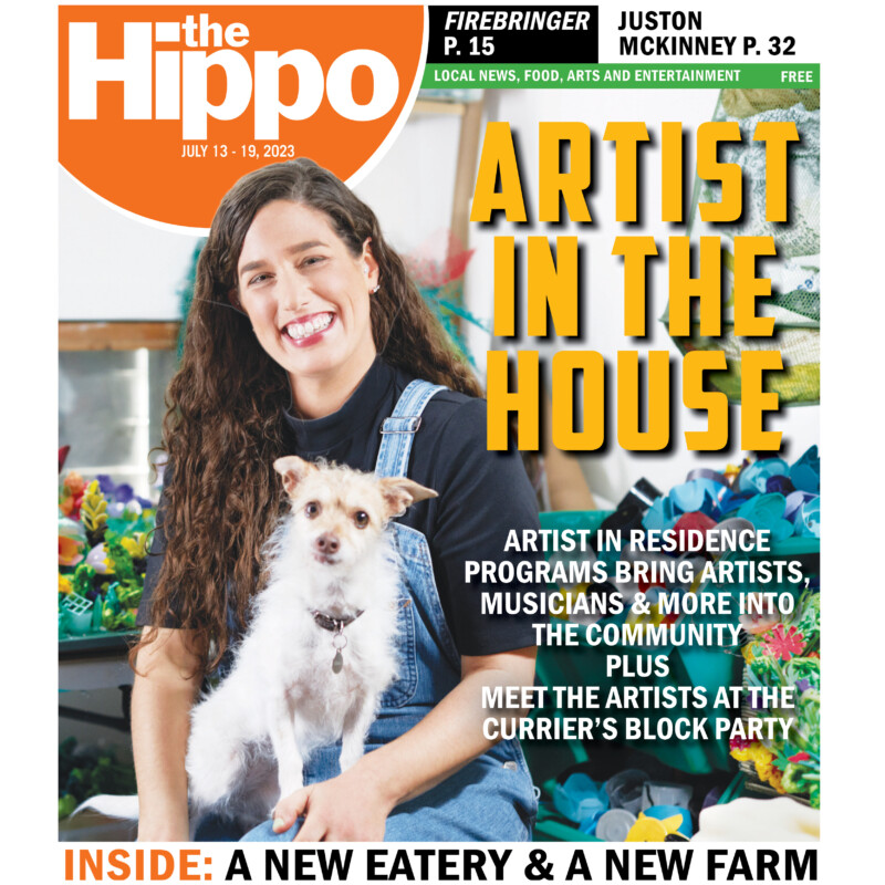 front cover of Hippo showing long haired woman sitting in studio with small dog on her lap