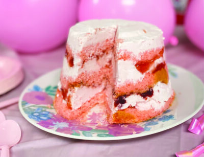 small round cake with layers of cake, strawberries, and strawberry ice cream