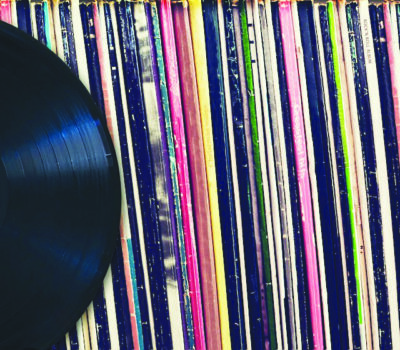 close up of row of record albums seen from the side, record leaning against them