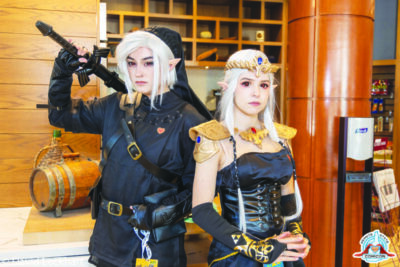 young man and woman dressed in character costumes standing in hotel