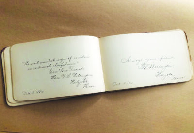 Image of vintage autograph book with various signatures on the pages