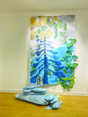textile art hanging on wall, showing nature scene