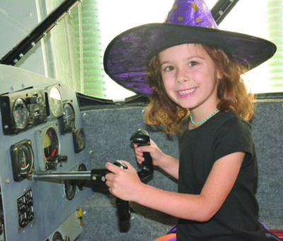 Child in witch costume exploring the aviation museum. Courtesy photo.