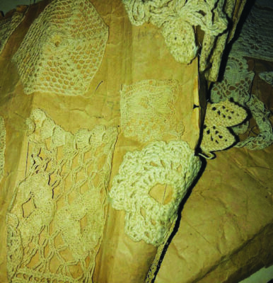 thick brown paper with crocheted doilies attached