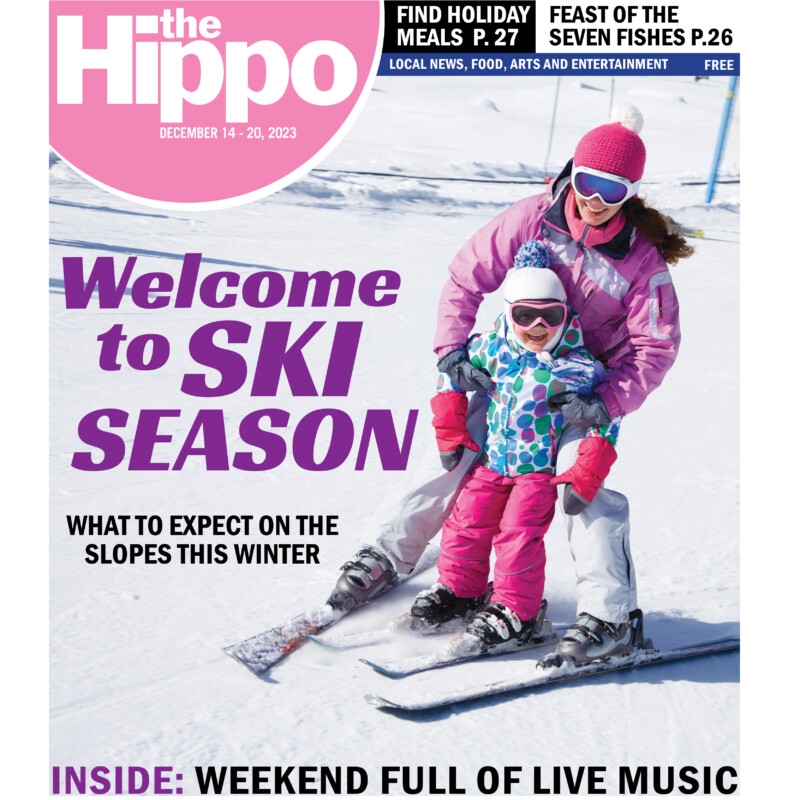 frontpage of Hippo showing woman on skis holding small girl on skis between her legs at the bottom of snowy hill