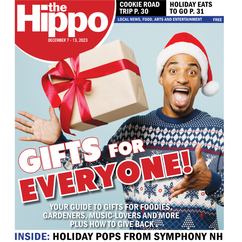 frontpage of the hippo showing excited black man wearing santa hat throwing a wrapped present into the air