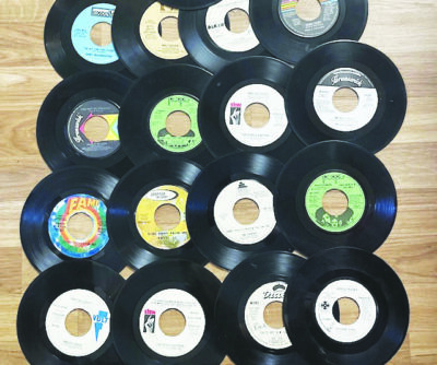 vintage 45 albums laid out on wooden floor