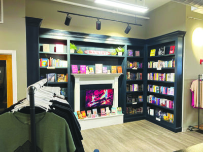 corner in bookstore with shelves against wall and fake fireplace