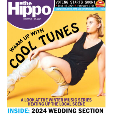 front page of hippo magazine showing woman posing in tall boots and mini dress with words cool tunes