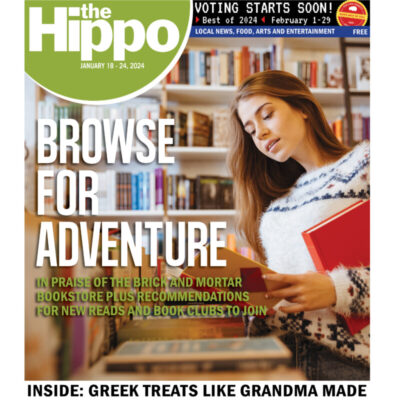 front cover of Hippo showing young woman browsing in bookstore, holding one book and opening another