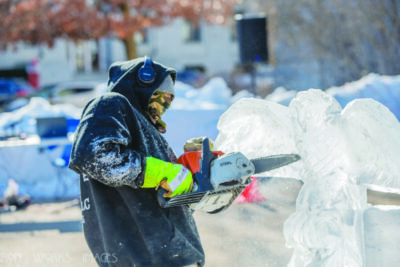 Man making an ice sculpture using a chainsaw