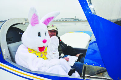 Easter bunny sitting in the cockpit of a plane