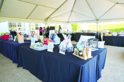 table under outdoor tent filled with packaged goods