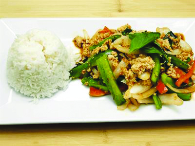 stir fried veggies with side of rice on rectangular plate