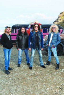 The four band members of the band Stryper posing for a photo