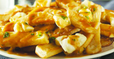 close up of french fries and cheese covered in gravy