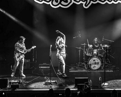 band members playing on stage under dramatic lights