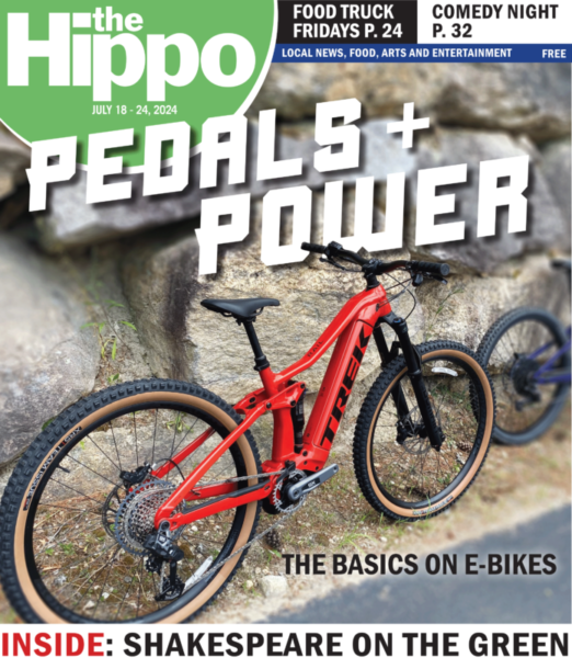 front cover of Hippo showing red e-bike leaning against stone wall, text Pedals plus power