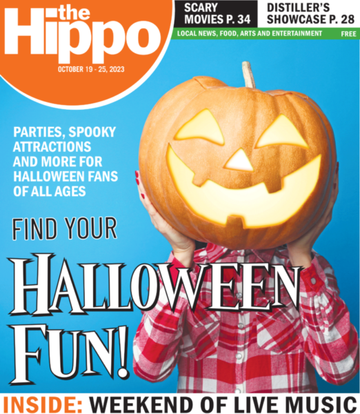 front page showing woman in red plaid shirt holding up jack o'lantern in front of her head with text find your halloween fun