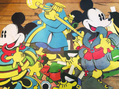 pile of Mickey Mouse paper dolls and different costumes