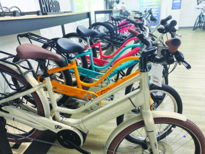 row of e-bikes in store, different colors