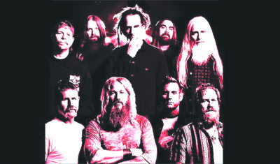 collage of middle aged band members, most with long hair and beards, on dark background