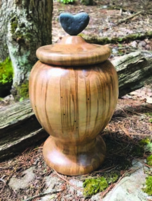 carved wooden jar with heart on lid, glossy surface showing wooden striations