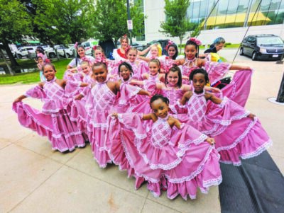 group of girls wearing fancy pink dresses, posing outside, young girls in dance troupe