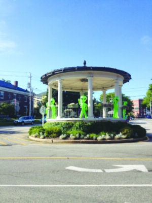 gazebo in center of road green blowup aliens set beside each column facing out and waving