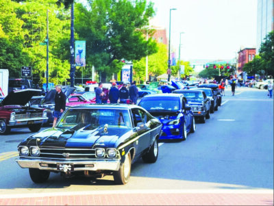 cars driving down a street in line