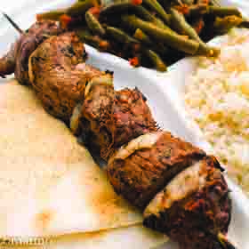 meat kebab with flatbread, rice, and green beans