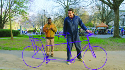 screenshot from Harold and the Purple Crayon with adult and child character drawing life-size bike with crayon